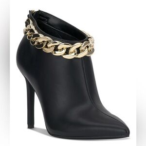 Sleek Black Heeled Boots with Gold Chain Accent